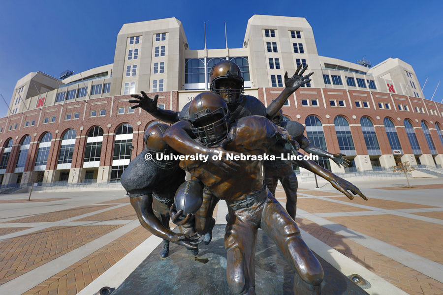 Football statue, The Legacy, is located outside of east Memorial Stadium. March 1, 2016. Photo by Craig Chandler / University Communications