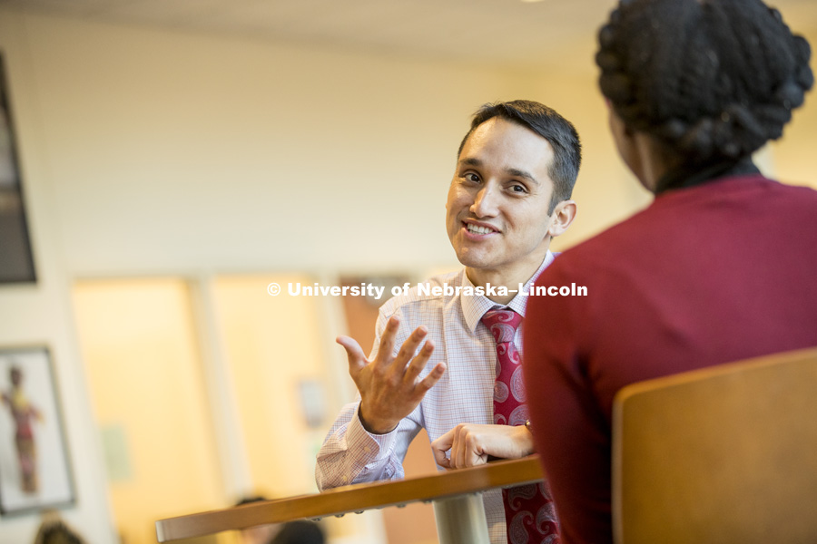 Moises Padilla, Assistant Director of the Office of Academic Success and Intercultural Services (OASIS) talks with a co-worker in the Jackie Gaughan Multicultural Center. January 10, 2017. Photo by Craig Chandler / University Communication.