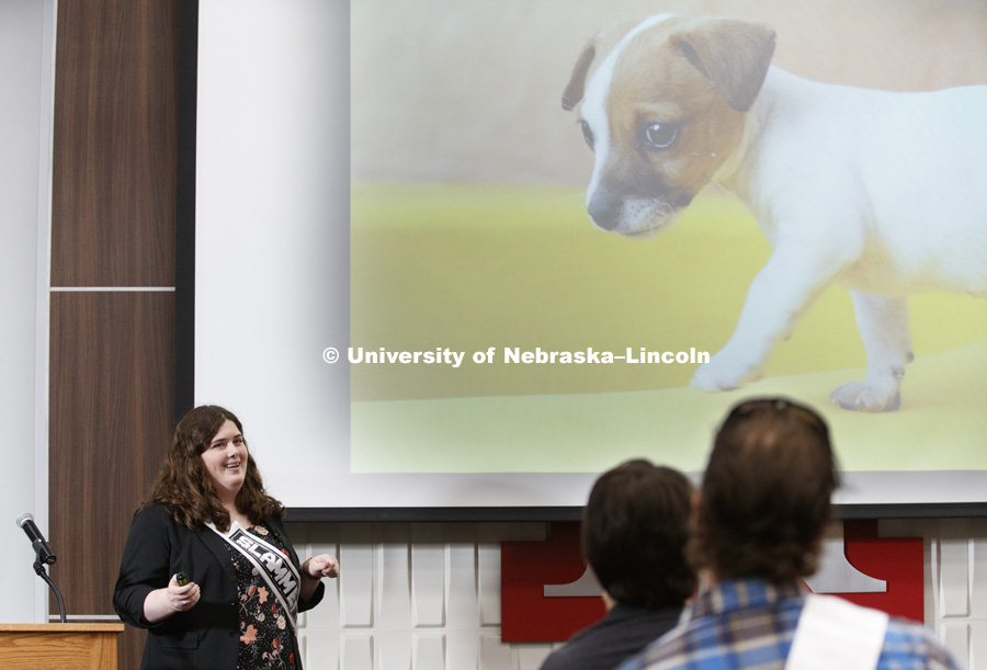 Catie Brown, a graduate student in Psychology, uses a photo of a puppy to elicit an emotional response as an example of her work in CB3.  Science Slam. April 10, 2017. Photo by Craig Chandler / University Communication.