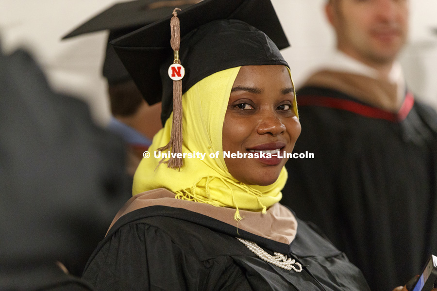 Fatma Abdallah Ahmed Saoy awaits the beginning of the ceremony. Students earning graduate and professional degrees received their diplomas Friday afternoon in Lincoln's Pinnacle Bank Arena. Undergraduate commencement is Saturday morning in the Arena. More