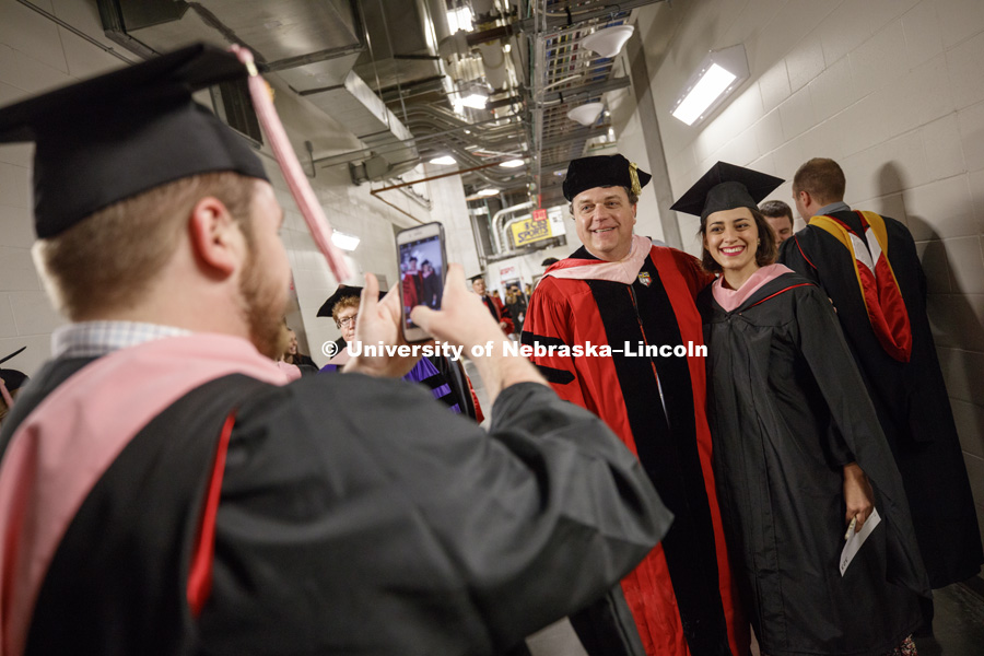 Backstage awaiting the ceremony to begin. Grads pose for pictures. Students earning graduate and professional degrees received their diplomas Friday afternoon in Lincoln's Pinnacle Bank Arena. Undergraduate commencement is Saturday morning in the Arena.