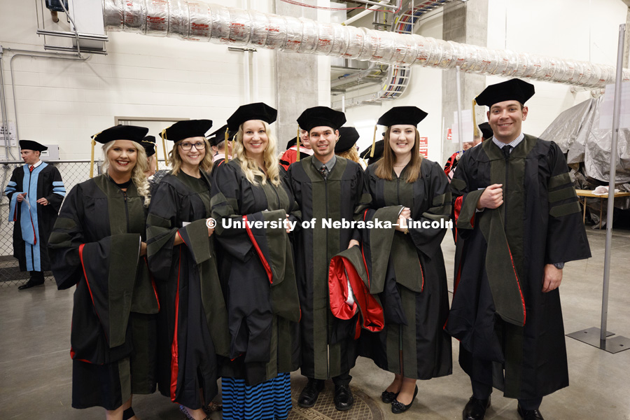 Backstage awaiting the ceremony to begin. Grads pose for pictures. Students earning graduate and professional degrees received their diplomas Friday afternoon in Lincoln's Pinnacle Bank Arena. Undergraduate commencement is Saturday morning in the Arena.