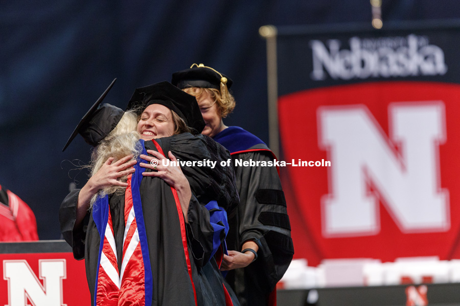 Aubrey Rose Streit Krug hugs Professor Frances Kaye after Streit Krug received her doctoral hood. Students earning graduate and professional degrees received their diplomas Friday afternoon in Lincoln's Pinnacle Bank Arena. Undergraduate commencement is
