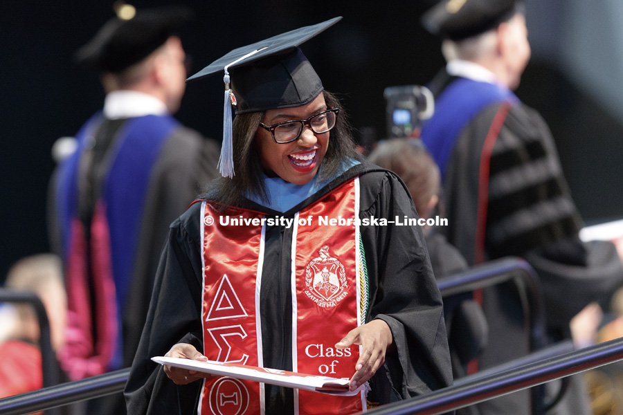 Carnetta Griffin smiles after receiving her Master's Degree. Students earning graduate and professional degrees received their diplomas Friday afternoon in Lincoln's Pinnacle Bank Arena. Undergraduate commencement is Saturday morning in the Arena. More