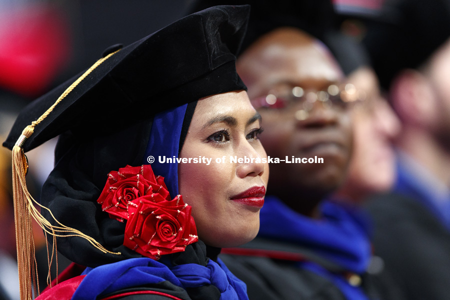 Kismiantini listens to the commencement speaker. Students earning graduate and professional degrees received their diplomas Friday afternoon in Lincoln's Pinnacle Bank Arena. Undergraduate commencement is Saturday morning in the Arena. More than 3,000