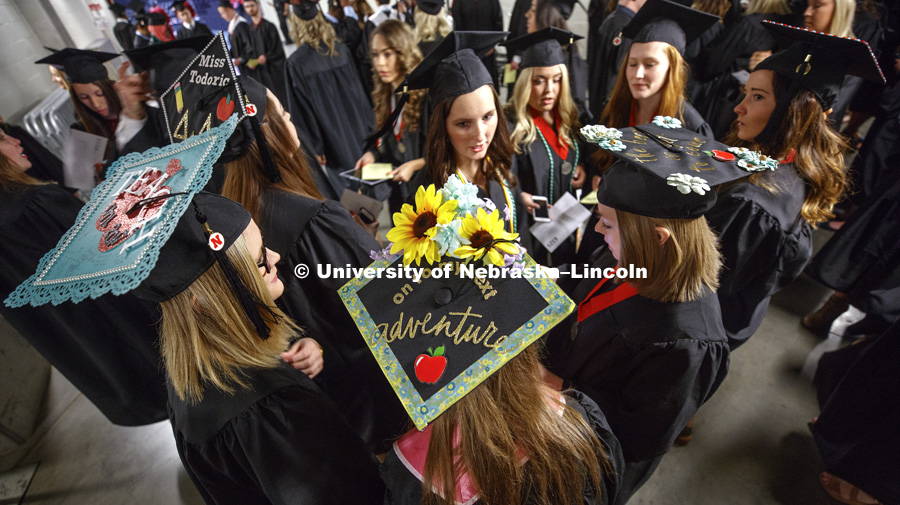 Future teachers and their decorated mortarboards congregate in the hallways of Pinnacle Bank Arena as the students arrive for commencement. Students received their undergraduate diplomas Saturday morning in Lincoln's Pinnacle Bank Arena. 2452 degrees were