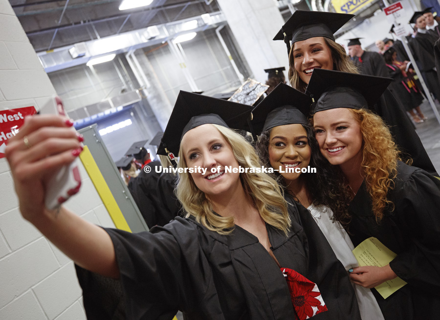 Megan Gould, Kiara Moody. Cassandra Jane Wilka and Courtney Belden take a selfie while waiting for commencement to begin. Students received their undergraduate diplomas Saturday morning in Lincoln's Pinnacle Bank Arena. 2452 degrees were awarded Saturday