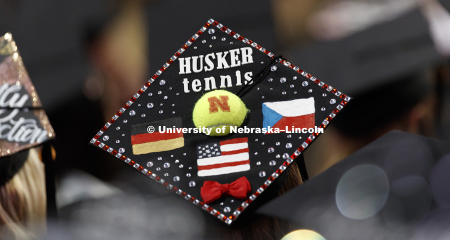 Katerina Matysova, a Husker tennis athlete from Erding, Germany, sports a distinctive mortarboard in the sea of graduates. Students received their undergraduate diplomas Saturday morning in Lincoln's Pinnacle Bank Arena. 2452 degrees were awarded Saturday