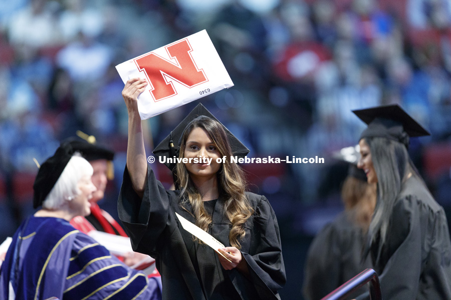 Nadia Syed shows off her College of Education and Human Sciences diploma to family and friends in the arena. Students received their undergraduate diplomas Saturday morning in Lincoln's Pinnacle Bank Arena. 2452 degrees were awarded Saturday morning. May