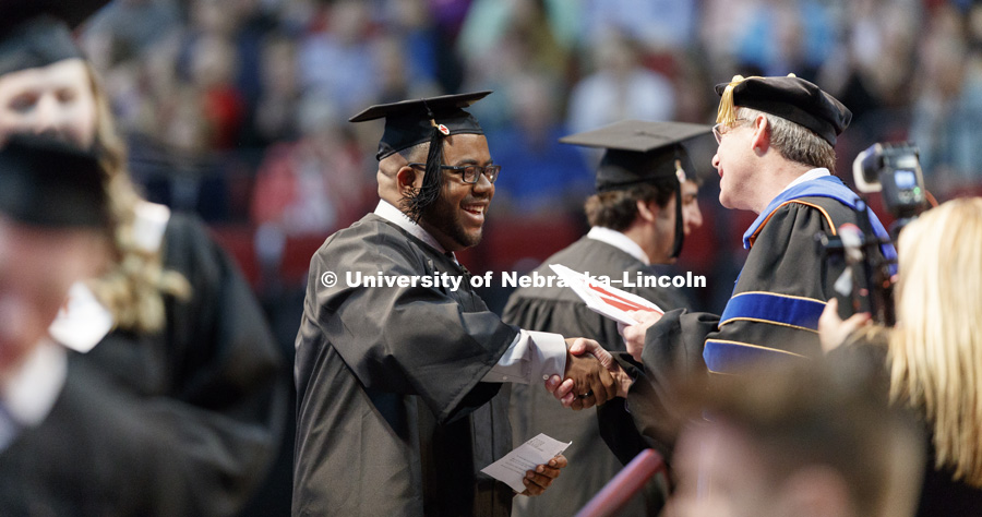Marvin Cunningham receives his engineering degree Saturday morning. Students received their undergraduate diplomas Saturday morning in Lincoln's Pinnacle Bank Arena. 2452 degrees were awarded Saturday morning. May 6, 2017. Photo by Craig Chandler /