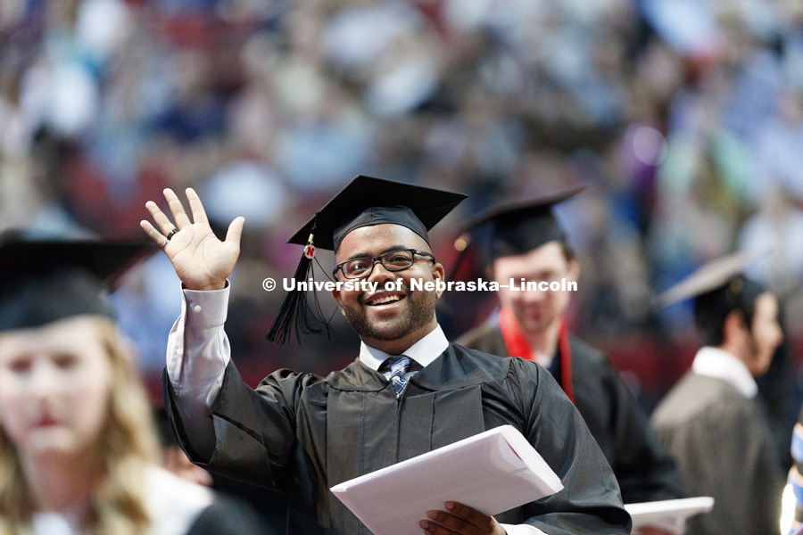 Marvin Cunningham waves to family and friends in the arena after receiving his Engineering diploma. Students received their undergraduate diplomas Saturday morning in Lincoln's Pinnacle Bank Arena. 2452 degrees were awarded Saturday morning. May 6, 2017.