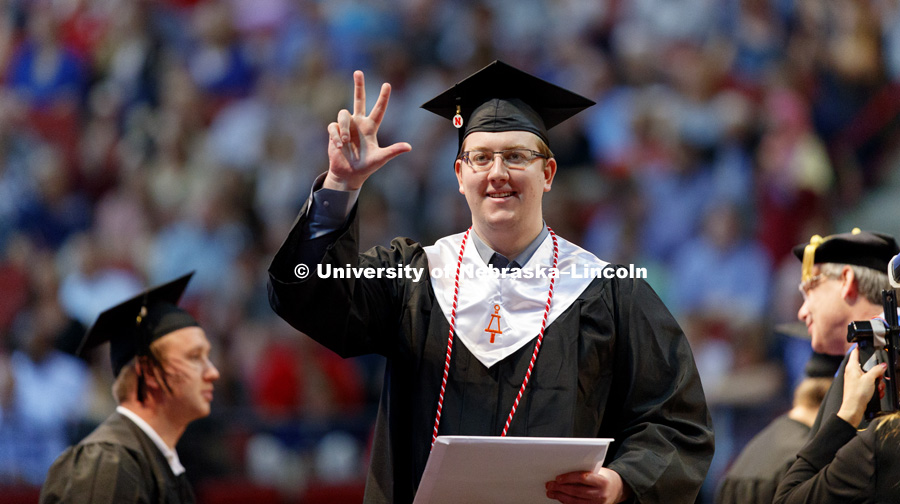 Vojislav Medic waves to family and friends in the arena after receiving his College of Engineering diploma. Students received their undergraduate diplomas Saturday morning in Lincoln's Pinnacle Bank Arena. 2452 degrees were awarded Saturday morning. May 6
