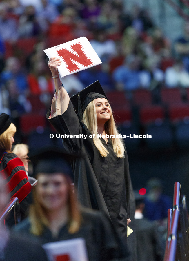 Cami Kopetka shows off her College Business diploma to family and friends in the arena. Students received their undergraduate diplomas Saturday morning in Lincoln's Pinnacle Bank Arena. 2452 degrees were awarded Saturday morning. May 6, 2017. Photo by