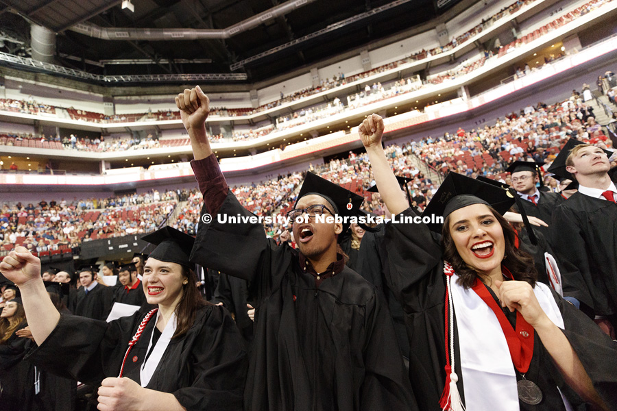 Kathleen Johnson, Joseph Abebe and Brittany Albin shout out "Go Big Red" with the rest of the graduates to finish the ceremony. Students received their undergraduate diplomas Saturday morning in Lincoln's Pinnacle Bank Arena. 2452 degrees were awarded
