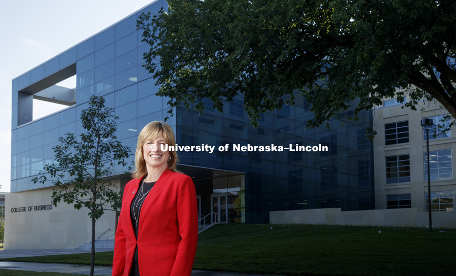 Kathy Farrell, interim Dean of the College of Business. She stands in front of the new building, Hawks Hall, opening in the fall. July 14, 2017. Photo by Craig Chandler / University Communication.