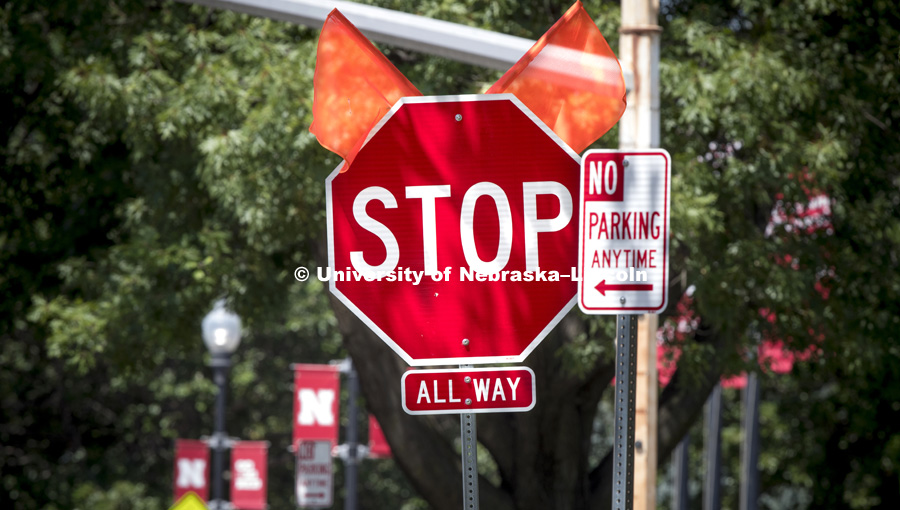 A Big Red Stop sign is lined up with other GBR signs as part of several new four-way stops along 16th Street. The change is one of many driving changes on campus which include making 16th a two-way street. July 25, 2017. Photo by Craig Chandler /