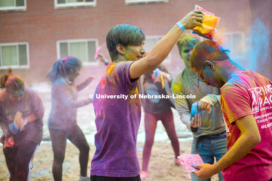 Students celebrate Holi, the Indian festival of spring, colors and celebration. Students tossed colored corn starch into the air and onto each other on the Selleck volleyball courts. April 15, 2018. Photo by Alyssa Mae for University Communication.