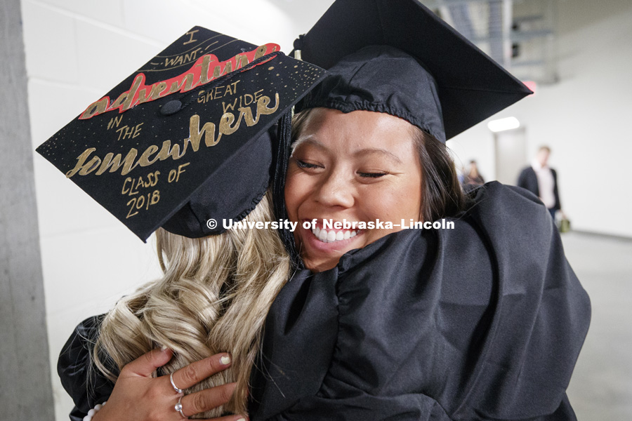 Lily Nguyen hugs her friend Jennifer Castellano as they line up for commencement Saturday morning. Summer Commencement at Pinnacle Bank Arena. August 11, 2018. Photo by Craig Chandler / University Communication.
