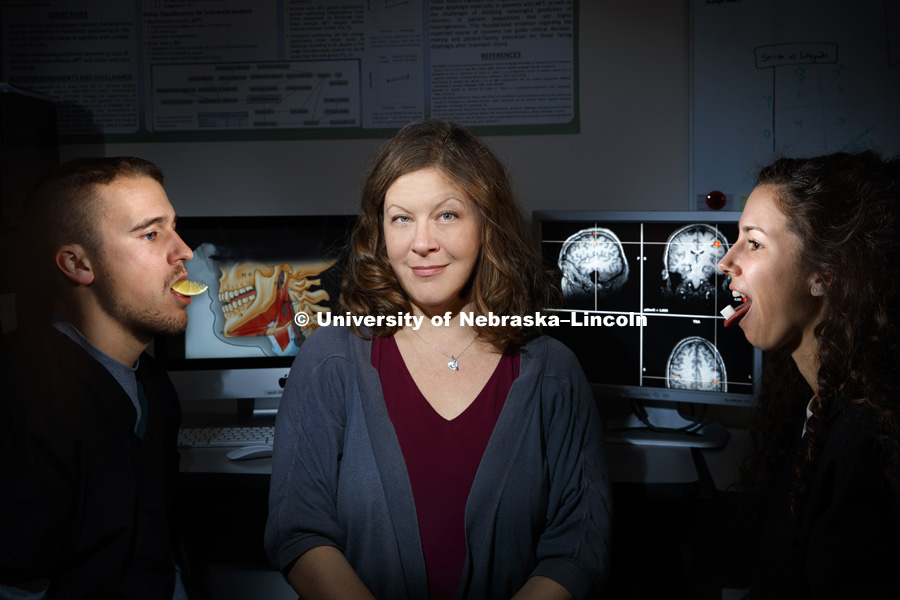 Angela Dietsch, Assistant Professor Special Education and Communication Disorders, is using the sense of taste and MRI scans to help stroke victims recover their swallowing mechanics, PhD student Ross Westemeyer of North Liberty, IA, models sour while grad student Megan Asselin of Lincoln models sweet. November 12, 2018. Photo by Craig Chandler / University Communication.