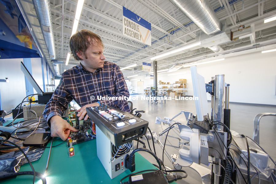 Jason Dumpert works with components in the console assembly area. Virtual Incision has relocated to the newest building on Nebraska Innovation Campus and expanded their footprint to include manufacturing areas for the surgical robots. December 20, 2018. Photo by Craig Chandler / University Communication.