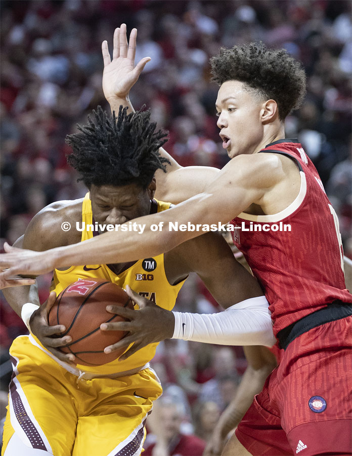 Nebraska's Isaiah Roby wraps up Minnesota's Daniel Oturu under the Gopher basket. Huskers men’s basketball game helped celebrate the university's 150th birthday with a halftime birthday party. The Huskers played against Minnesota. February 13, 2019. Photo by Craig Chandler / University Communication.