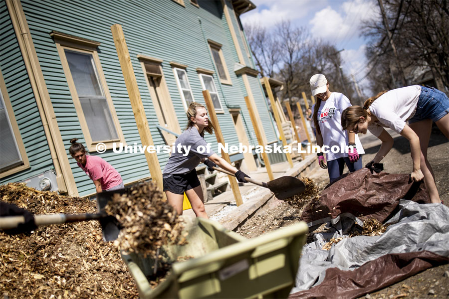 Alyse Dockter load mulch as they and others from Kappa Alpha Theta did yard work at a couple homes south of downtown. More than 2,500 University of Nebraska–Lincoln students, faculty and staff volunteered for the Big Event on April 6, completing service projects across the community. Now in its 13th year at Nebraska, the Big Event has grown to be the university's single largest student-run community service project. April 6, 2019. Photo by Craig Chandler / University Communication.