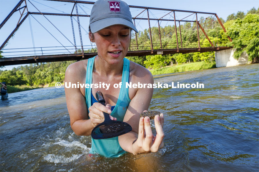 Kayla Vondracek, junior in Environmental Studies, looks over her sand sample. Jessica Corman, assistant professor in the School of Natural Resources, UCARE research group researching algae in the Niobrara River. Fort Niobrara National Wildlife Refuge. July 12, 2019. Photo by Craig Chandler / University Communication.