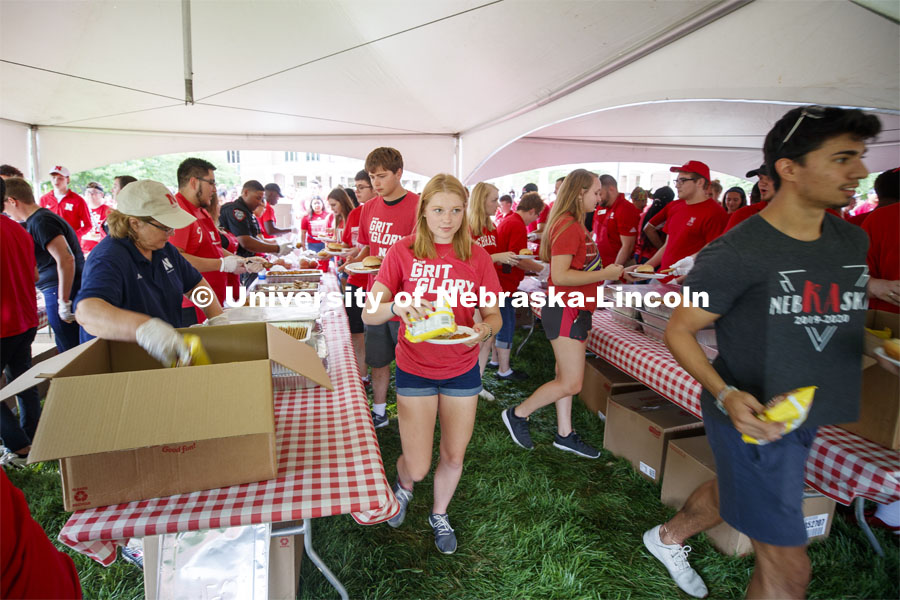 Students work their way through multiple food lines at the picnic. Big Red Welcome, Chancellor's BBQ for incoming freshman and new students on the greenspace by the Memorial Union. August 23, 2019. Photo by Craig Chandler / University Communication.