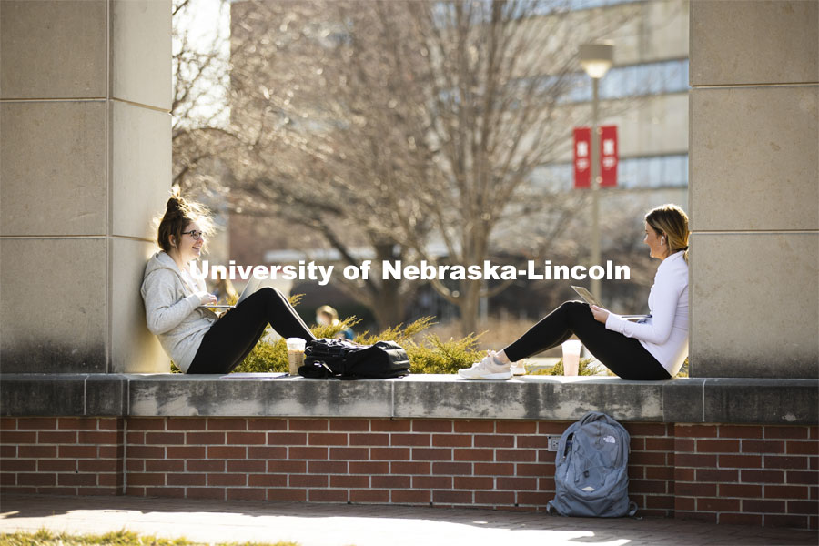 Madison Moran, left, a freshman from Kansas City, and Jenna Craven, a freshman from Norfolk, enjoy the warm sunshine. Warm weather on city campus. March 4, 2021. Photo by Craig Chandler / University Communication