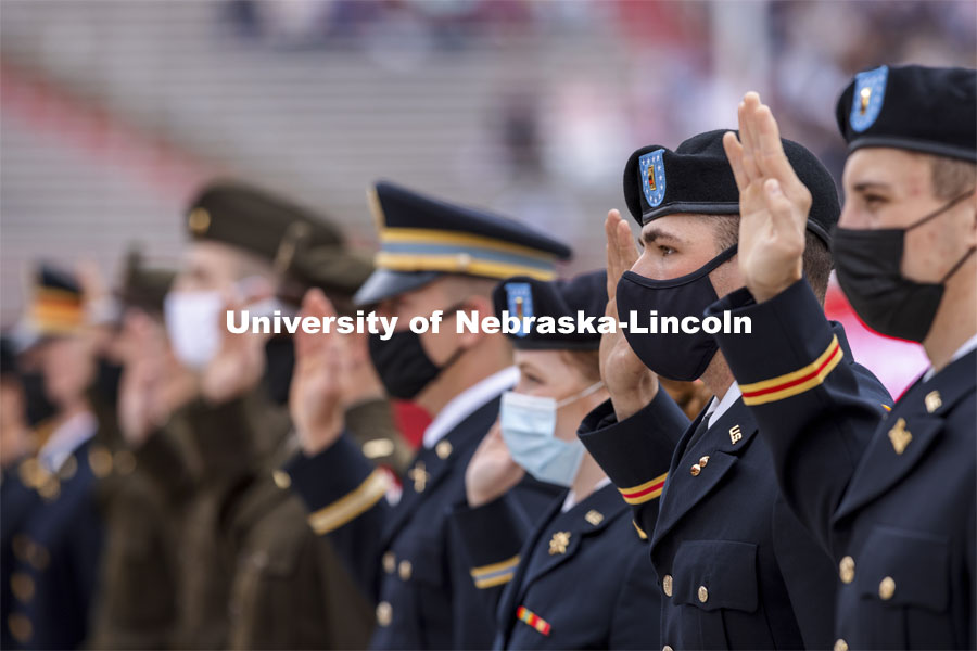 New Army Second Lieutenants including Tyler Mona recite the oath of enlistment at the beginning of the second commencement. The former ROTC cadets then changed into regalia to graduate with their colleges. The university conferred a record 3,594 degrees during the May commencement ceremonies. UNL Commencement in Memorial Stadium. May 8, 2021. Photo by Craig Chandler / University Communication.