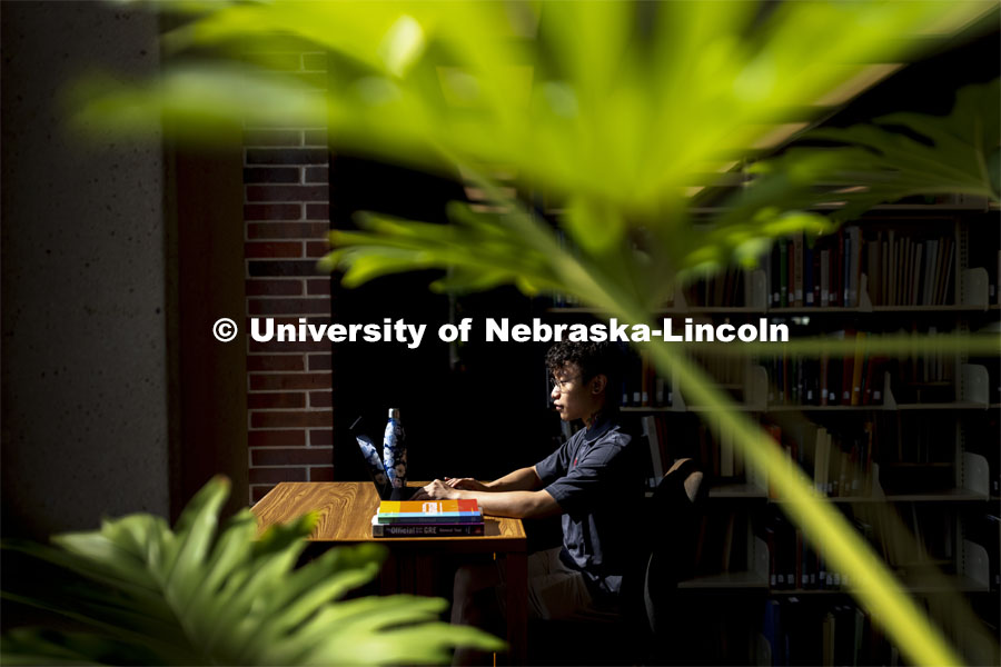 Daniel Nguyen, McNair scholar and senior in psychology, studies in Love Library. July 28, 2021. Photo by Craig Chandler / University Communication.