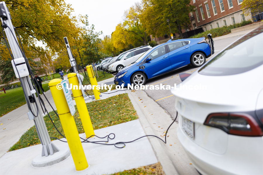 Electric cars recharge at the charging stations in front of the College of Business. October 26, 2021. Photo by Craig Chandler / University Communication
