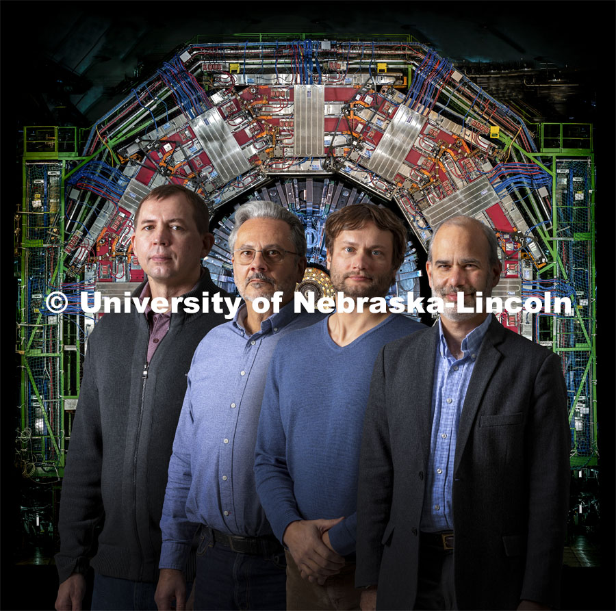 Ilya Kravchenko, Dan Claes, Frank Golf and Ken Bloom are members of Nebraska’s Department of Physics and Astronomy who collaborate with partners at the European Organization for Nuclear Research, known as CERN. Their work involves CERN’s Large Hadron Collider, an image of which is behind the researchers in this photo. November 23, 2021. Photo by Craig Chandler/University Communication.