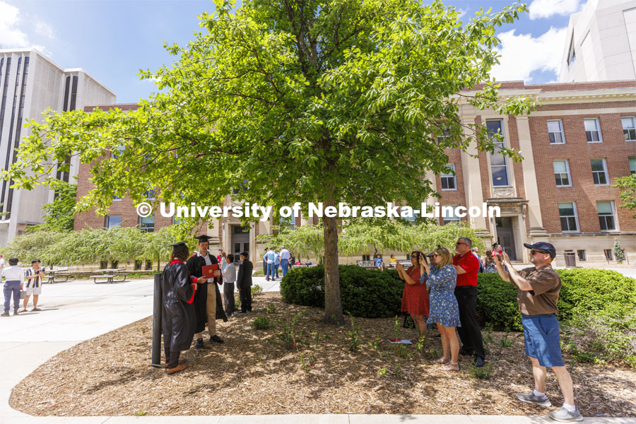 Friends and family of Kevin Snyder and Nicholas Gerstbrein take photos outside Avery Hall where the two School of Computing grads spent hours in the classroom. UNL undergraduate commencement in Memorial Stadium. May 14, 2022. Photo by Craig Chandler / University Communication.