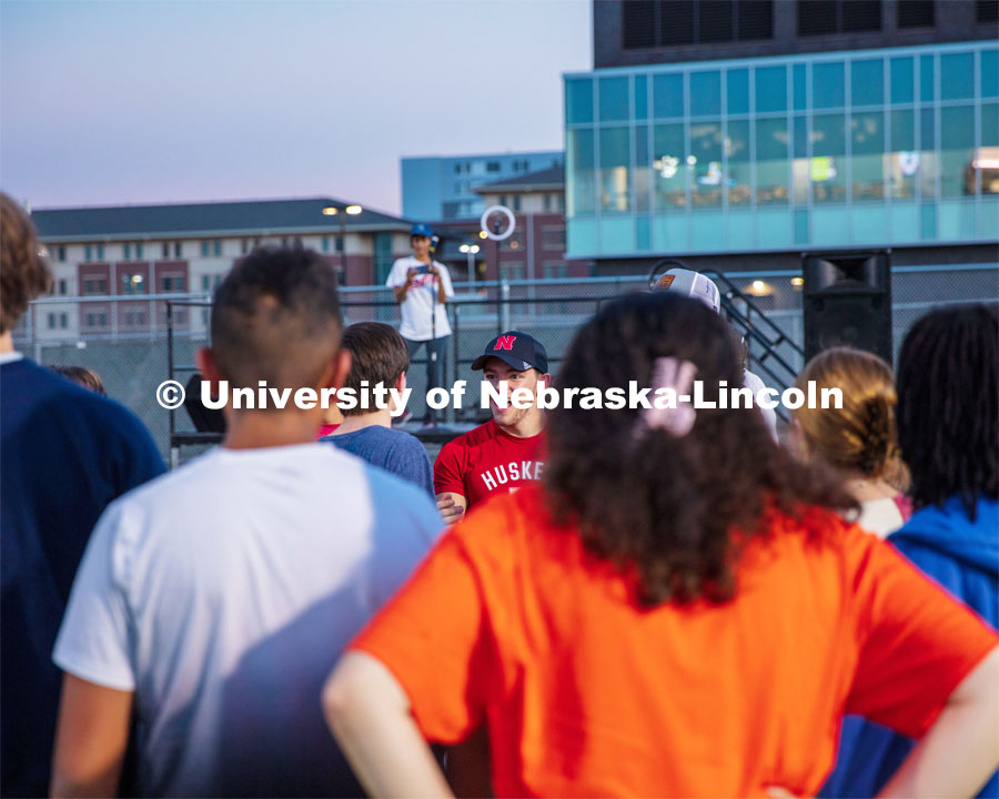 Students listen to the speaker during the Playfair activity at the Vine Street Fields Wednesday night as part of Big Red Welcome. August 17, 2022. Photo by Gus Kathol for University Communication.