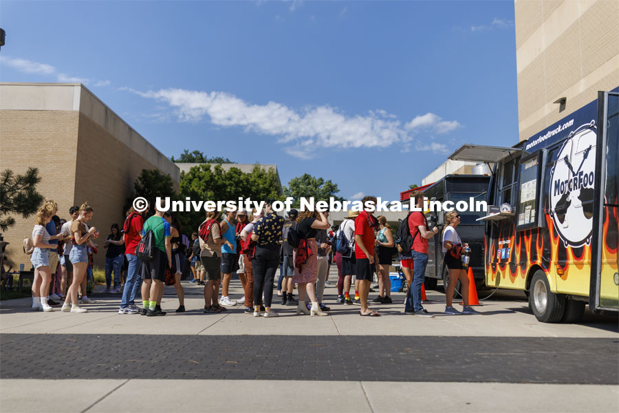 Students line up for the food trucks sponsored by the Hixon-Lied College of Fine and Performing Arts for their College Welcome for new and returning students. Big Red Welcome - College Welcome Programs. August 18, 2022. Photo by Craig Chandler / University Communication.