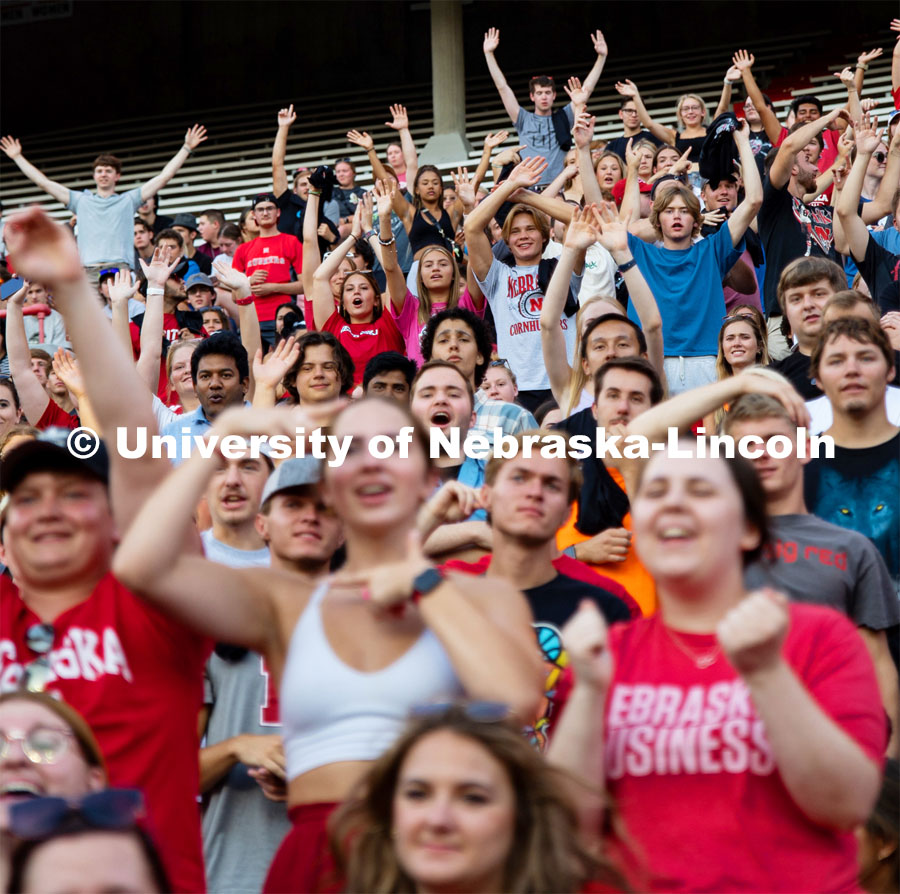 UNL students cheering and getting on their feet at the Boneyard Bash in Memorial Stadium. August 20, 2022. Photo by Kirk Rangel for University Communication.