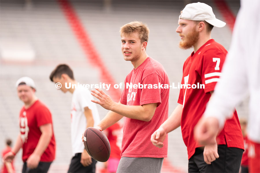 Husker fans play a game of football at the Nebraska vs Northwestern football watch party in Memorial Stadium. August 27, 2022. Photo by Jordan Opp for University Communication.