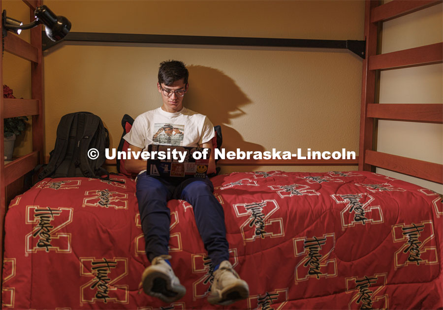 A student uses their laptop to study in their University Suites Residence Hall room. Housing Photo Shoot in University Suites Residence Hall. September 27, 2022. Photo by Craig Chandler / University Communication.