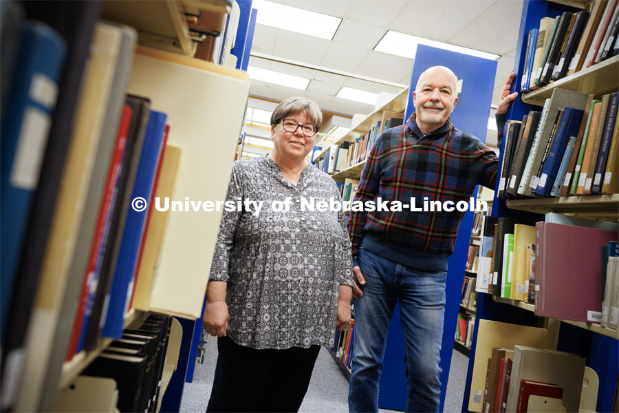Joanie Barnes (left) and Tom McFarland stand in the stacks of Love Library. The duo founded the Genealogy over Lunch group. February 27, 2023. Photo by Craig Chandler / University Communication.
