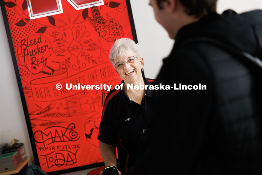 Nebraska's Lory Erving chats with a student at the Cather Dining register. Erving, a native of Hazel, South Dakota, has worked at the university for 35 years. She moved to Lincoln in 1985 after graduating from South Dakota State University with a bachelor's degree in music. Erving is a checker/cashier at Cather Dining Service. Her favorite part of the job: “Laughing and joking with the students, answering questions, providing support for coworkers, students and staff plus the challenge of balancing my sales and tickets at the end of my shift are all things I enjoy”. March 30, 2023. Photo by Craig Chandler / University Communication.