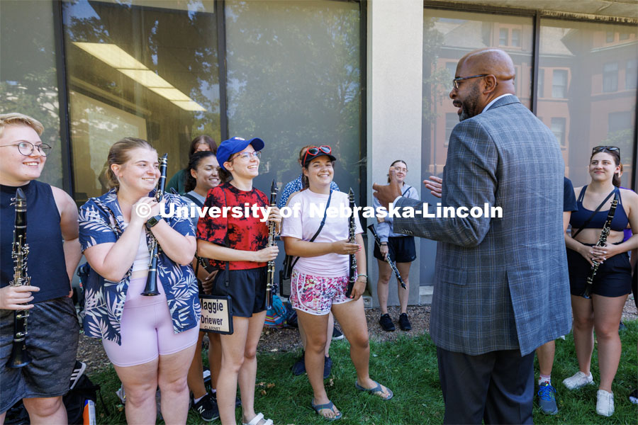 Chancellor Rodney Bennett talks with the clarinet section of the Cornhusker Marching Band during a break in their practice. August 17, 2023. Photo by Craig Chandler/ University Communication.