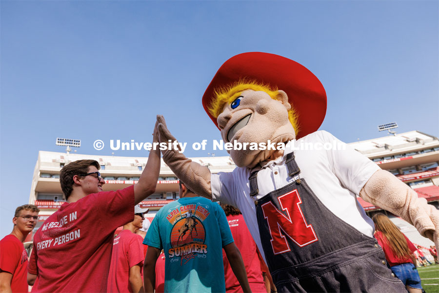 Students high five Herbie Husker at the Tunnel Walk in Memorial Stadium. August 18, 2023. Photo by Craig Chandler / University Communication.
