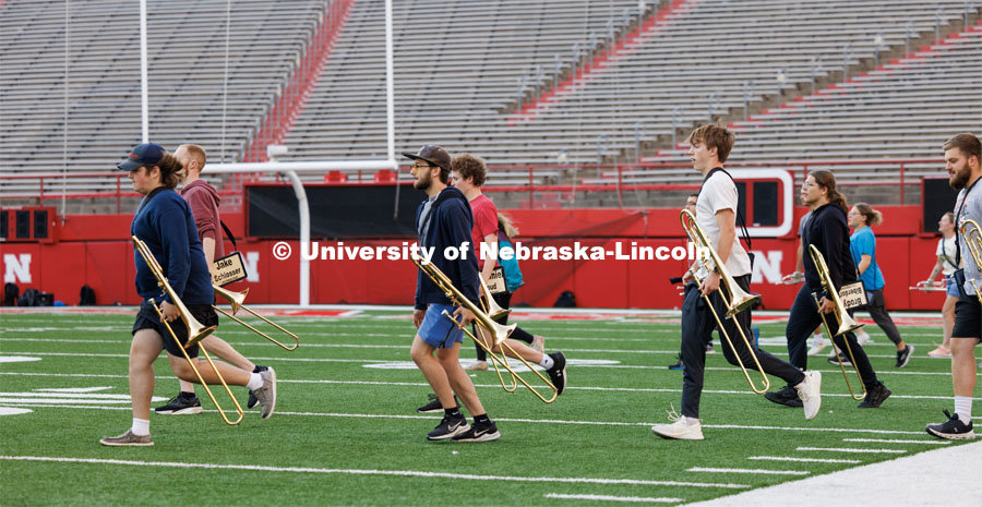 Cornhusker Marching Band runs onto the field during their early morning practice. September 19, 2023. Photo by Craig Chandler / University Communication.
