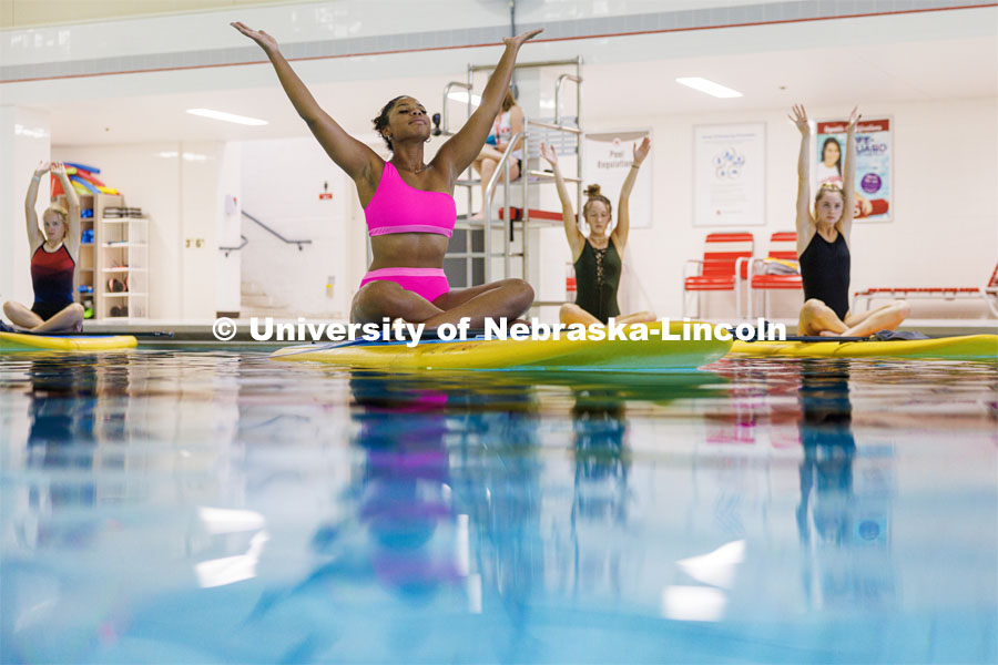Jazlynn Sanders peacefully floats in the rec center pool Wednesday during Paddleboard Yoga. The session was part of National Women's Health and Fitness Day. September 27, 2023. Photo by Craig Chandler / University Communication.