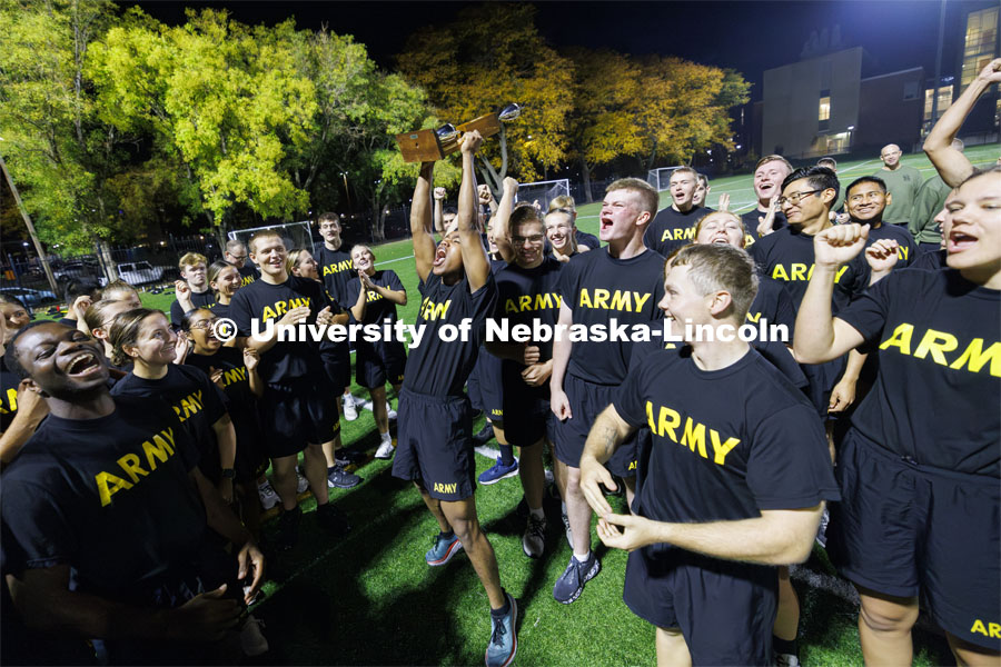 Cadet Remy Abdulahi hoists the trophy after the Army cadets won the meet. ROTC Joint Field Meet is like an ROTC Olympics for the Nebraska cadets and midshipmen. Army, Air Force and Navy/Marine cadets and midshipman compete in events such as Maneuvering Under Fire, Log Sit-ups, Tug-Of-War, Casualty Evacuation and Ultimate Frisbee. Army beat Navy in a sudden death 4x400 relay to claim the title. October 26, 2023. Photo by Craig Chandler / University Communication.