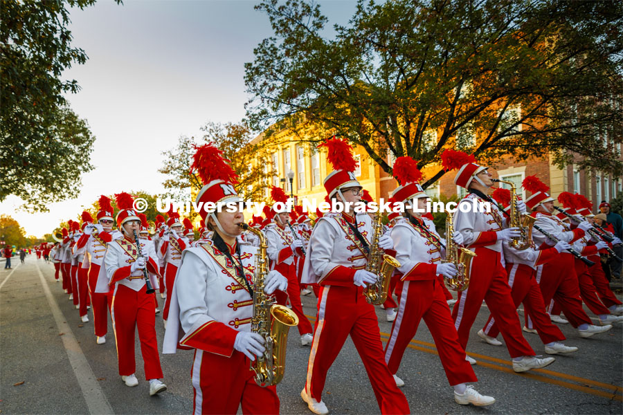 The Cornhusker Marching Band marches down R Street to begin the parade. Homecoming parade and Cornstock. October 27, 2023. Photo by Craig Chandler / University Communication.
