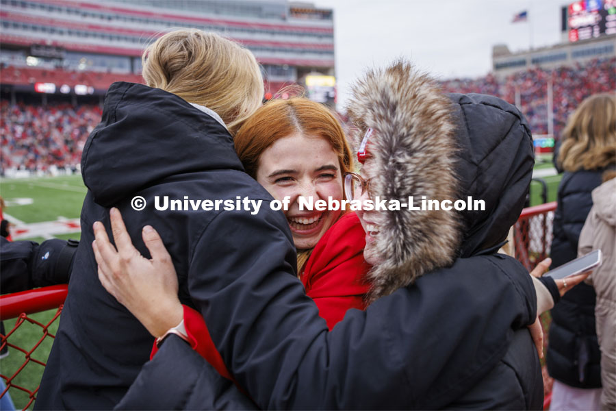 Hannah-Kate Kinney of Omaha is sandwiched by her friends after she was crowned homecoming royalty at the University of Nebraska–Lincoln. Seniors Preston Kotik of Hooper and Hannah-Kate Kinney of Omaha were crowned homecoming royalty at halftime of the University of Nebraska–Lincoln versus Purdue game. Nebraska football versus Purdue Homecoming game. October 28, 2023. Photo by Craig Chandler / University Communication.