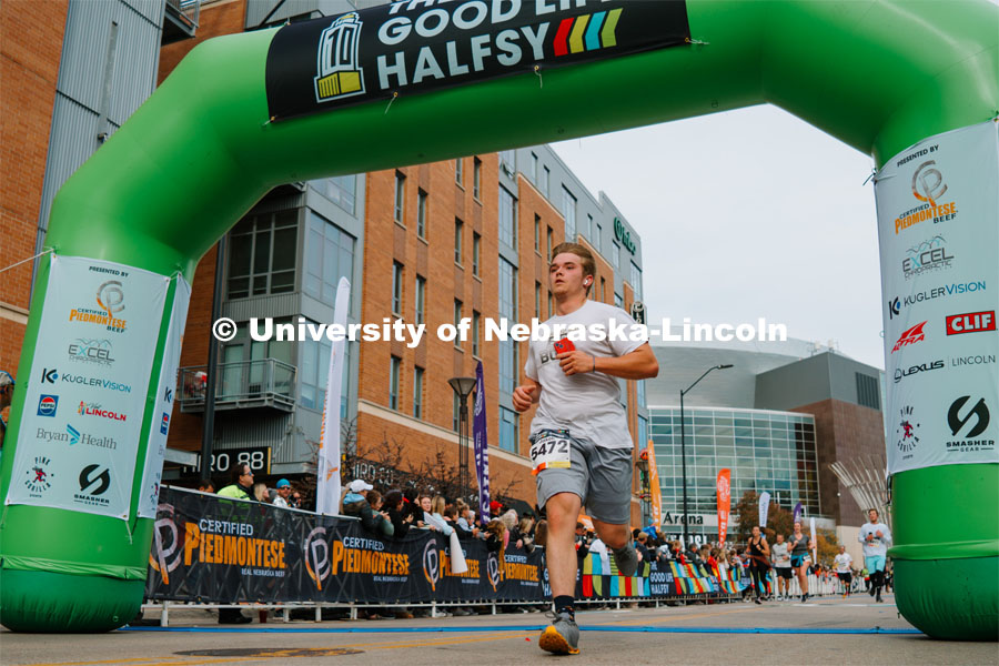 Runners cross the finish line. The Good Life Halfsy half marathon runs through the streets of Lincoln and end downtown in the Haymarket. About Lincoln at the Good Life Halfsy. November 5, 2023. Photo by Matthew Strasburger / University Communication.