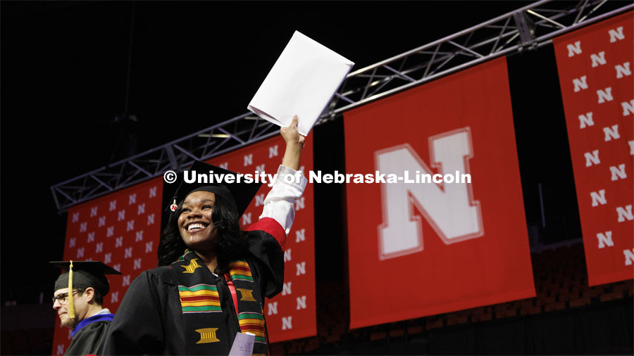 Jaevyn Carson waves to family and friends after receiving her CoJMC diploma. Winter undergraduate commencement in Pinnacle Bank Arena. December 16, 2023. Photo by Craig Chandler / University Communication and Marketing.